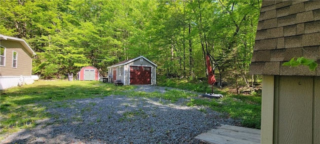 27 Birch Ln, Livingston Manor, NY 12768 - view of yard with a storage shed, a garage, and a wooded view