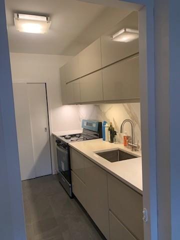 kitchen featuring range, backsplash, and sink