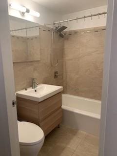 full bathroom featuring tile patterned flooring, vanity, toilet, and tiled shower / bath