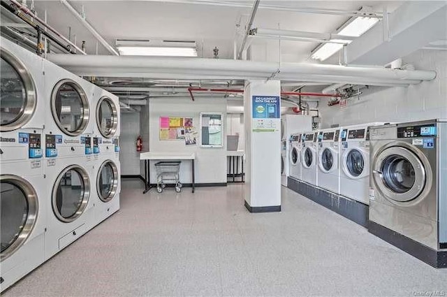 clothes washing area with washer and dryer and stacked washing maching and dryer