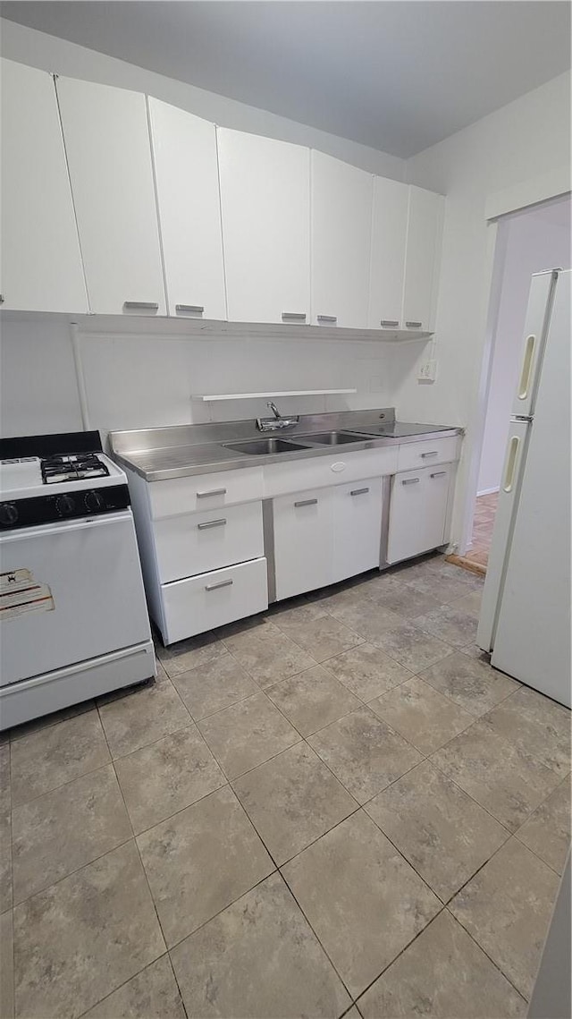 kitchen with white cabinetry, sink, and white appliances