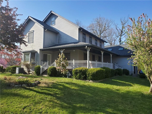 back of house with central AC, a yard, and a porch