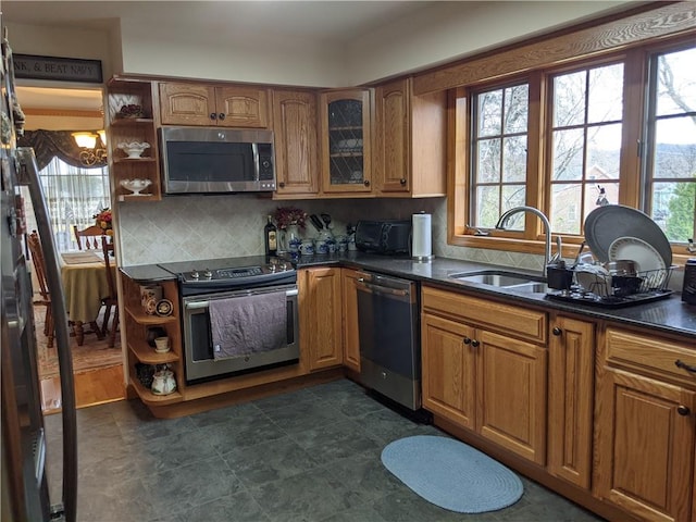 kitchen with decorative backsplash, sink, and stainless steel appliances