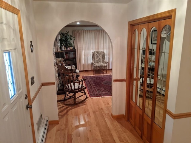 entrance foyer featuring light hardwood / wood-style floors and a baseboard heating unit