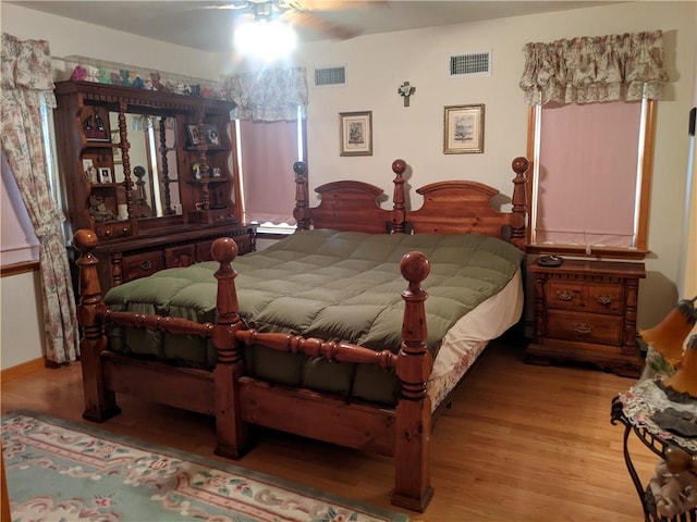 bedroom with ceiling fan and light hardwood / wood-style floors