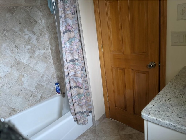 bathroom featuring shower / bath combo with shower curtain, vanity, and tile patterned flooring