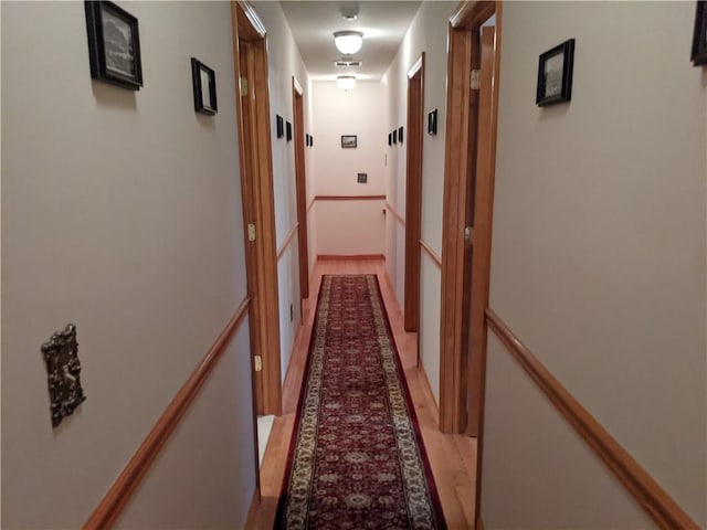 hallway with light hardwood / wood-style flooring