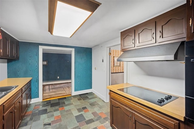 kitchen with black electric stovetop, dark brown cabinetry, and a baseboard heating unit