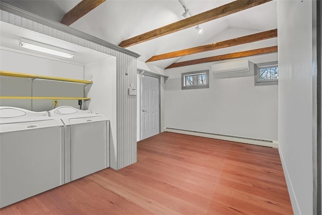 laundry room featuring washer and dryer, light hardwood / wood-style flooring, and a baseboard heating unit