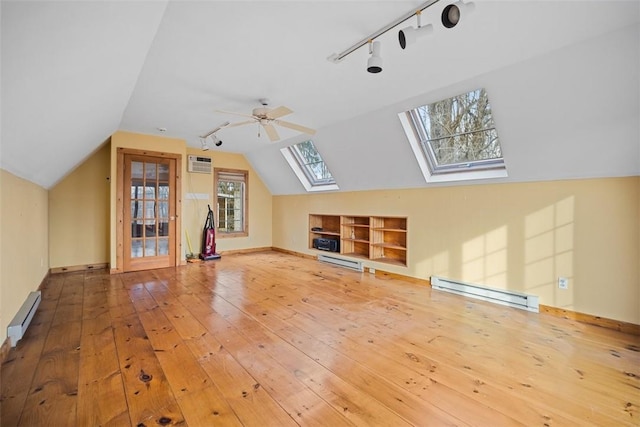 bonus room with hardwood / wood-style floors, ceiling fan, vaulted ceiling with skylight, and baseboard heating