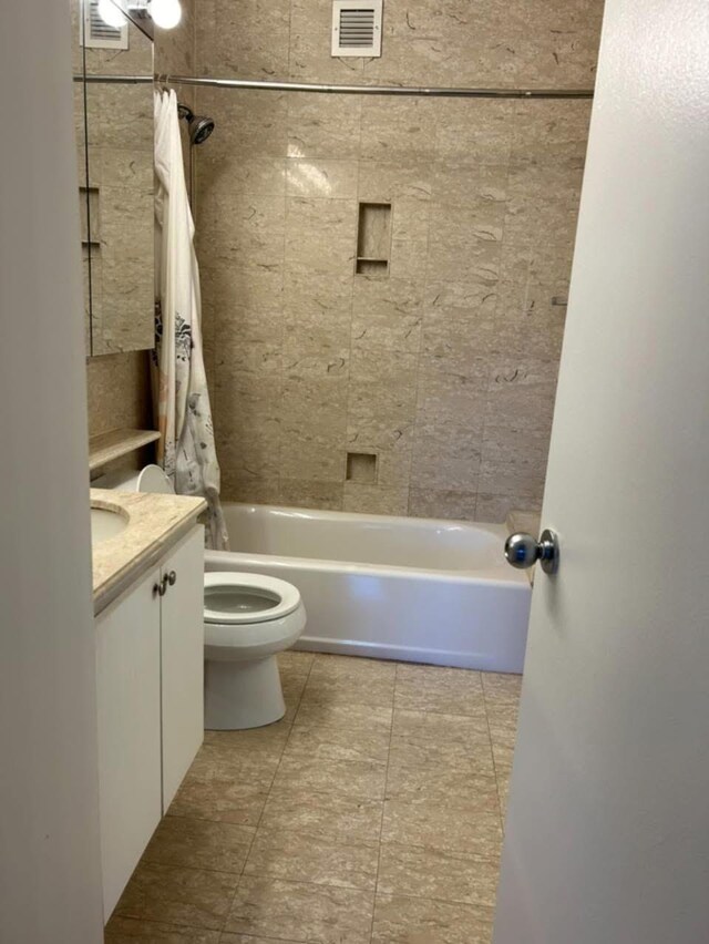full bath featuring shower / bath combo, vanity, toilet, tile patterned floors, and visible vents