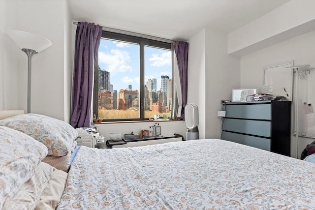 bedroom with a view of city