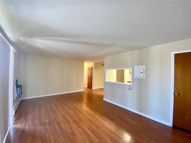 unfurnished room with hardwood / wood-style floors