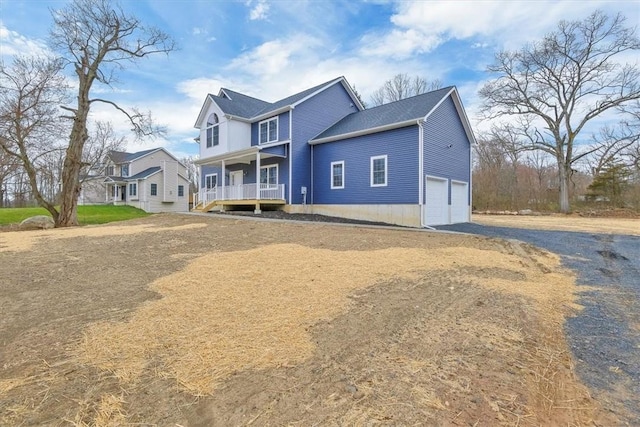 view of front of property with covered porch and a garage