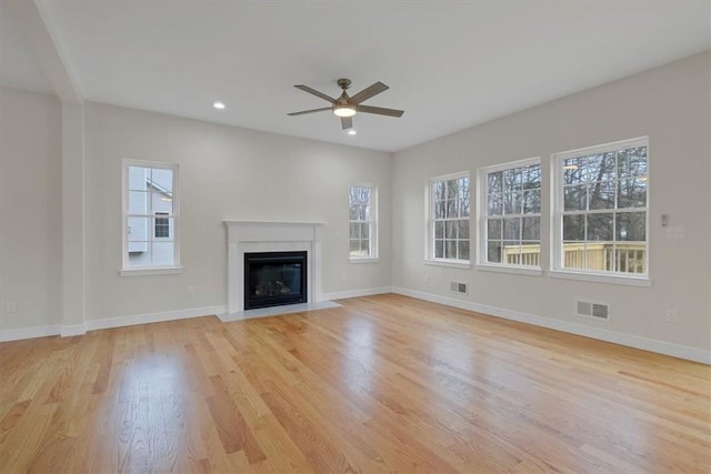 unfurnished living room featuring light hardwood / wood-style flooring and ceiling fan