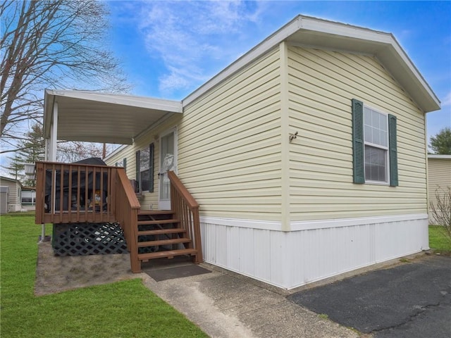 view of side of home with a lawn