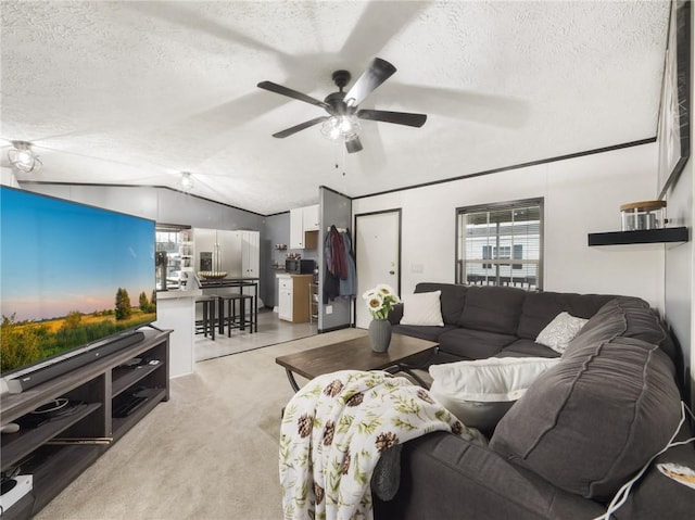 carpeted living room featuring ceiling fan, a textured ceiling, and vaulted ceiling