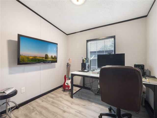 office with ornamental molding, a textured ceiling, light hardwood / wood-style flooring, and vaulted ceiling