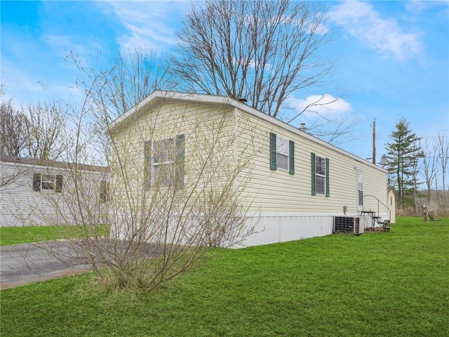 view of home's exterior featuring a lawn and cooling unit