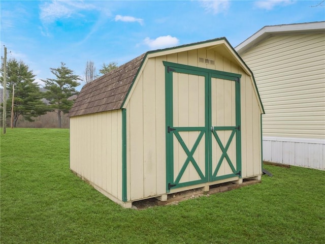 view of outbuilding featuring a yard