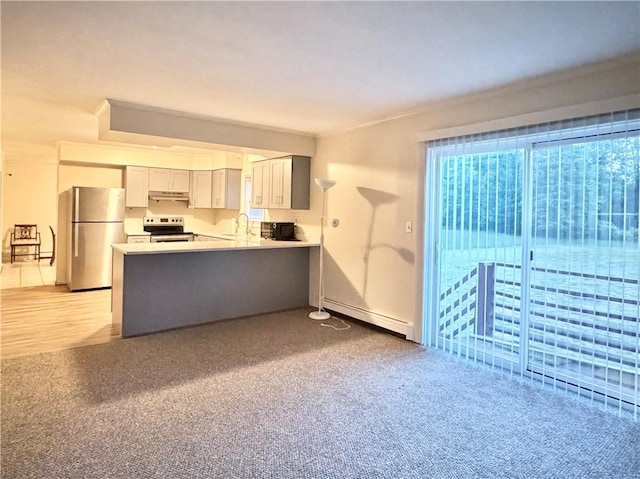 kitchen with sink, stainless steel appliances, a baseboard radiator, kitchen peninsula, and light wood-type flooring