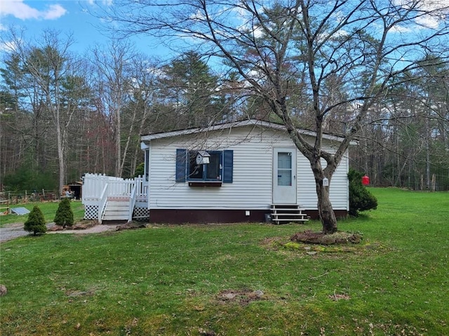 view of front of property featuring a front lawn and a deck