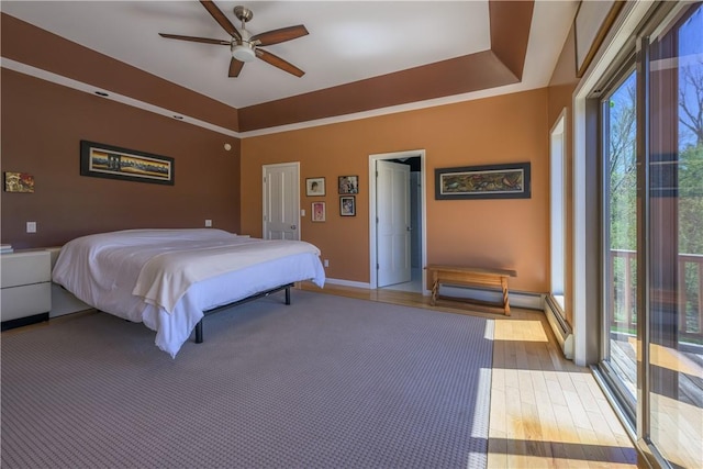 bedroom with ceiling fan, light hardwood / wood-style floors, and access to exterior