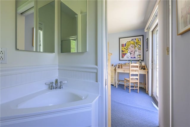 bathroom with a wealth of natural light and a washtub