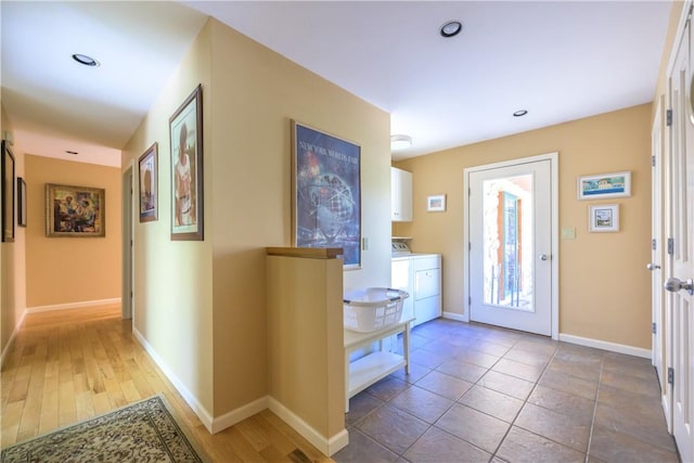 entrance foyer with dark wood-type flooring and independent washer and dryer