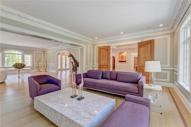 living room with light hardwood / wood-style flooring and ornamental molding