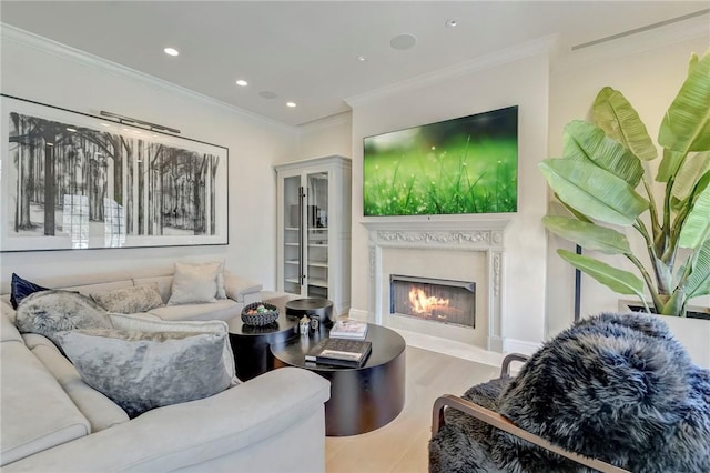 living room featuring light hardwood / wood-style floors and crown molding