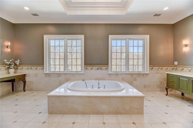 bathroom featuring vanity, a healthy amount of sunlight, tile walls, and tiled tub