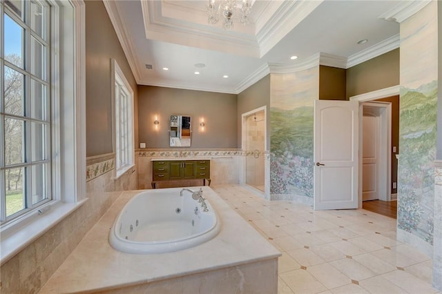 bathroom featuring a relaxing tiled tub, a healthy amount of sunlight, crown molding, and vanity