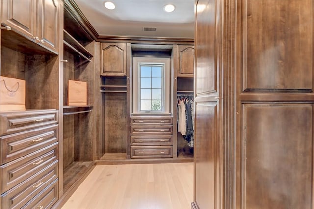 spacious closet with light hardwood / wood-style flooring