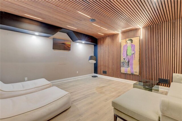 home theater room featuring light hardwood / wood-style flooring and wooden ceiling