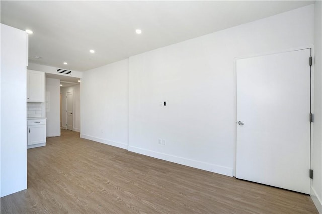 spare room with light hardwood / wood-style floors