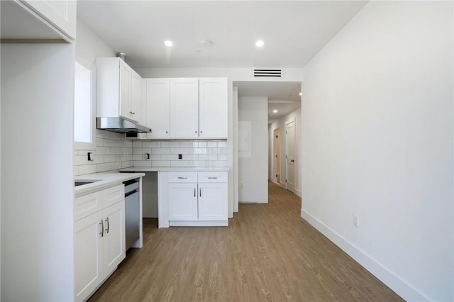 kitchen with dishwasher, light hardwood / wood-style floors, white cabinetry, and tasteful backsplash