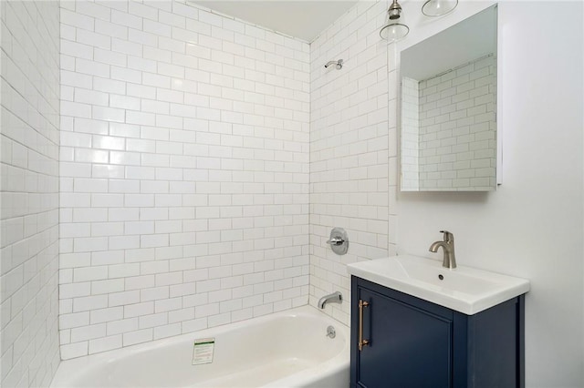 bathroom featuring vanity and tiled shower / bath combo