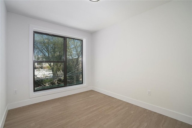 spare room featuring wood-type flooring