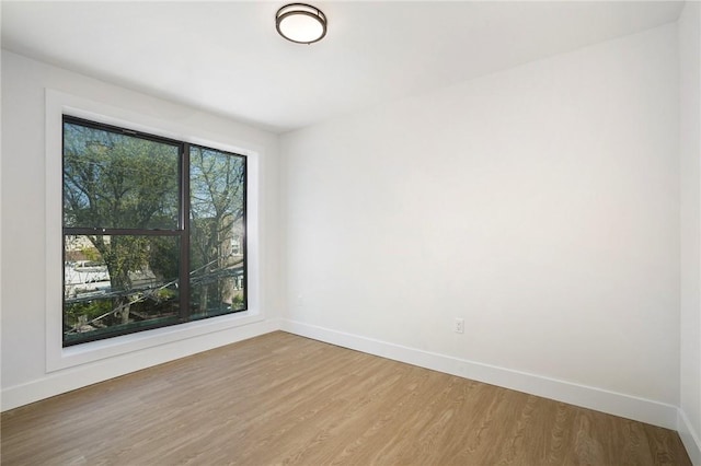 spare room with hardwood / wood-style floors