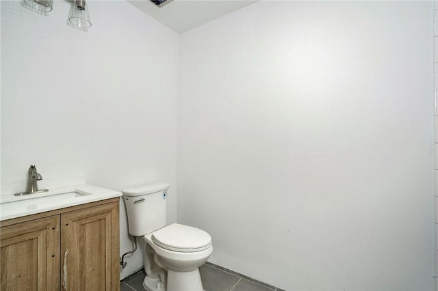 bathroom with tile patterned flooring, vanity, and toilet