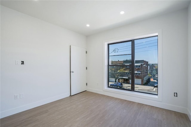 empty room with hardwood / wood-style floors