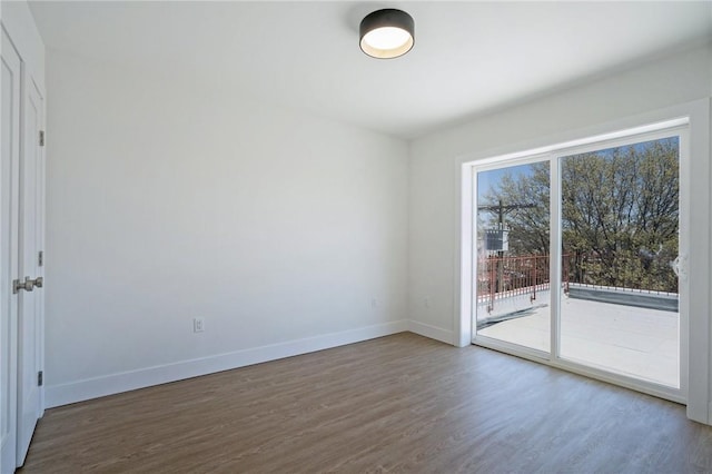 empty room with dark hardwood / wood-style floors