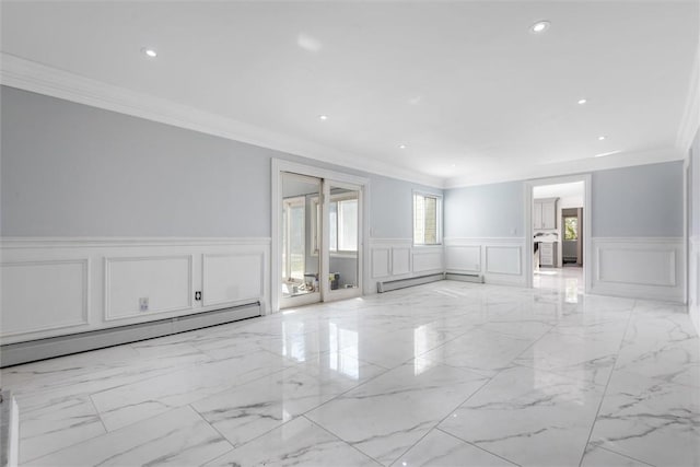 spare room featuring ornamental molding and a baseboard heating unit