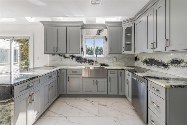 kitchen with decorative backsplash, stone countertops, gray cabinets, and a wealth of natural light