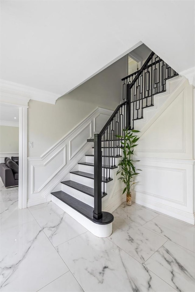 staircase featuring ornamental molding