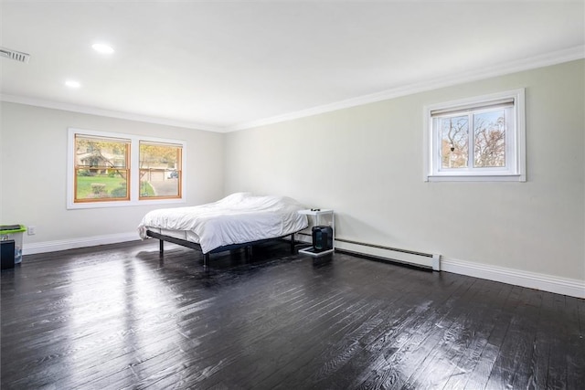 bedroom featuring dark wood-type flooring, crown molding, and a baseboard heating unit