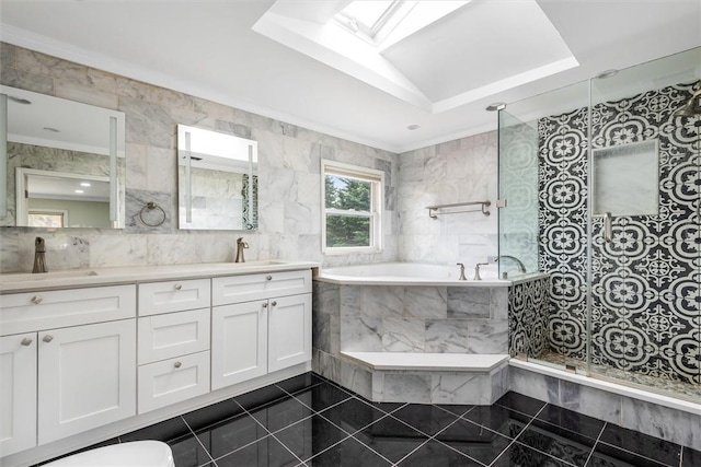 bathroom featuring vanity, a skylight, tile walls, and ornamental molding