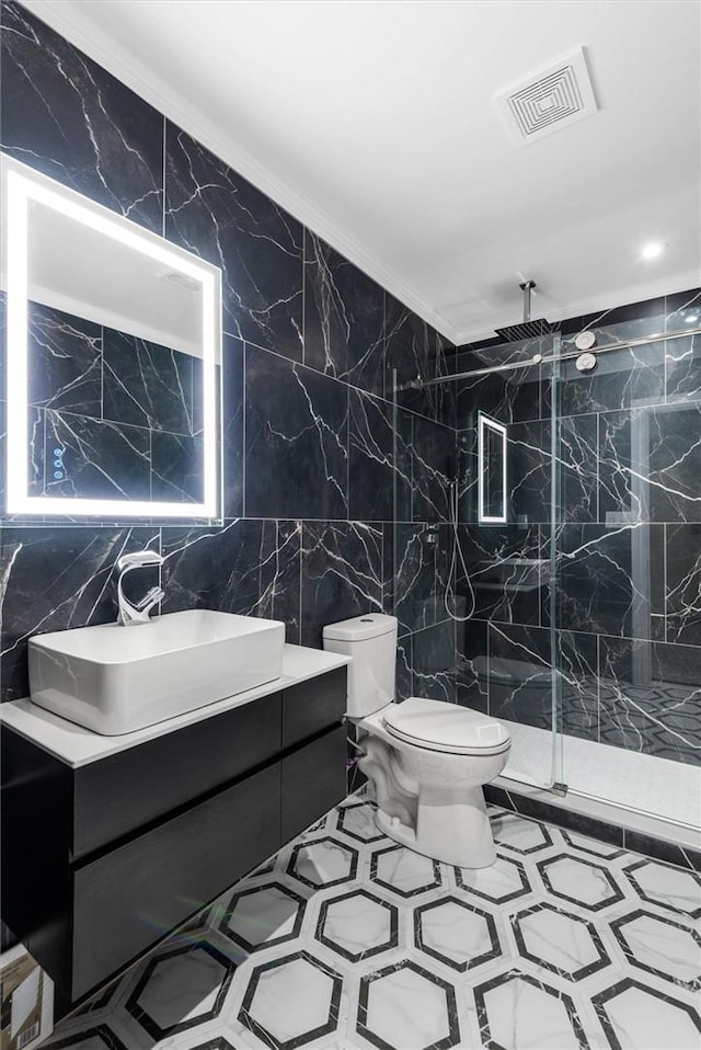 bathroom with vanity, toilet, ornamental molding, tile walls, and an enclosed shower