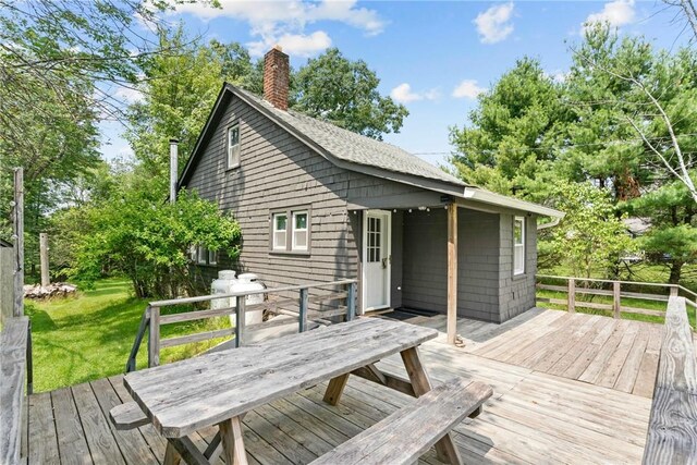 wooden deck with a lawn